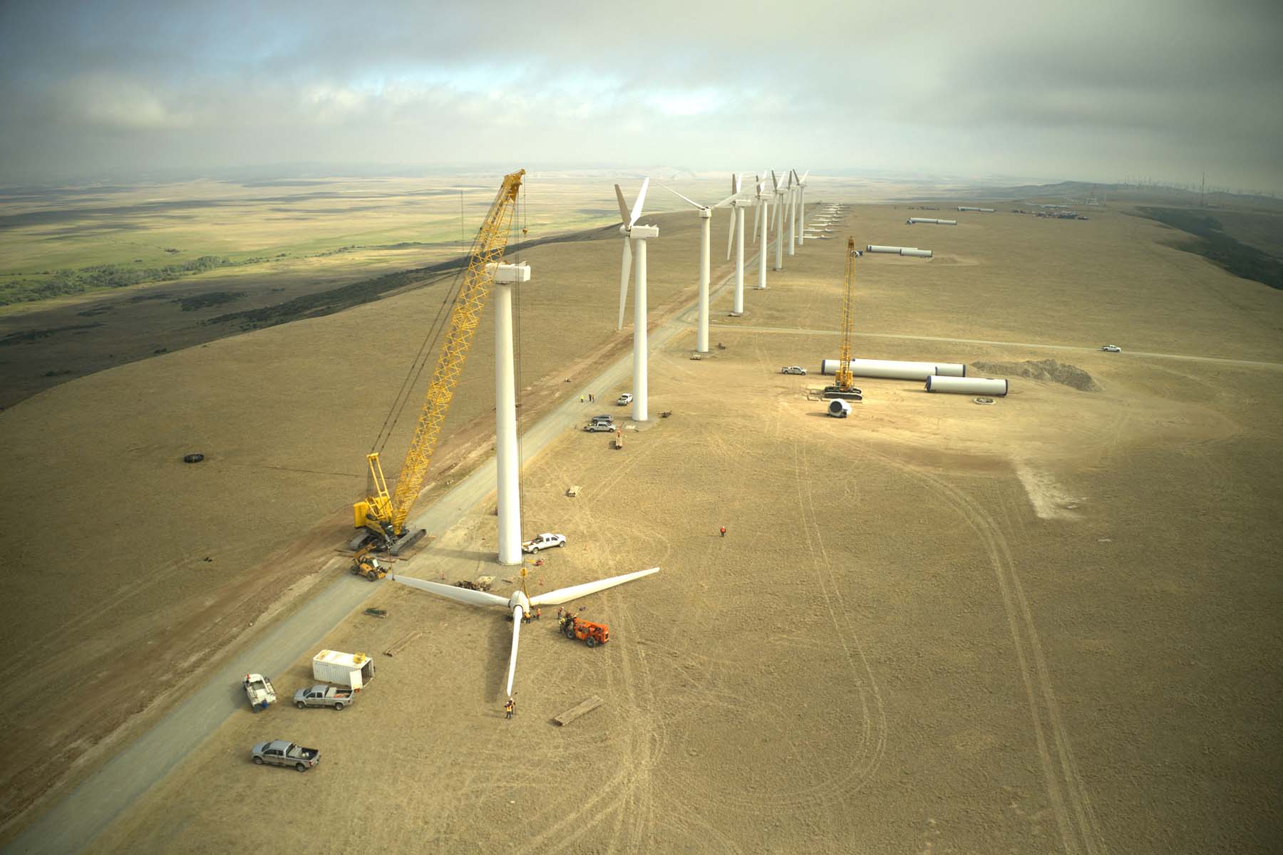 Field of wind turbines with one turbine being erected